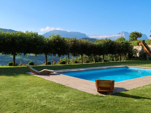 a swimming pool in a yard with a view of a mountain at Apartment Residence Egger - n-102 by Interhome in Villandro