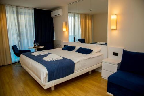 a bedroom with a large bed and a mirror at Orbi city - Premium Class Rooms N1 in Batumi