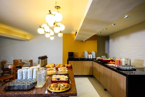 a buffet in a hotel room with food on a table at Nordeste Palace Hotel - Fortaleza in Fortaleza