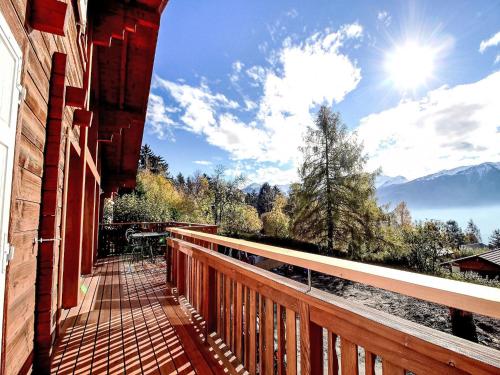 a balcony of a house with a view of the mountains at Chalet L'Eden by Interhome in Ovronnaz