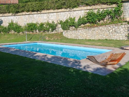 a swimming pool with a deckchair and a chair and a chair at Apartment Residence Egger - n-301 by Interhome in Villandro
