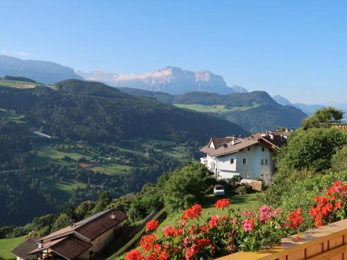 a village in the mountains with flowers at Apartment Residence Egger 303 by Interhome in Villandro