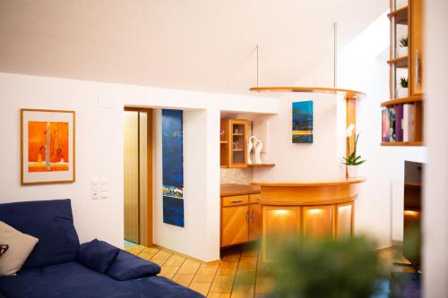 a living room with a couch and a kitchen at Petzen Panorama in Feistritz ob Bleiburg