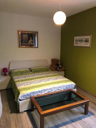 a bedroom with a bed and a teddy bear at Lakes of Fusine three border area in Fusine in Valromana