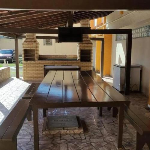 a wooden table in the middle of a patio at Refúgio Laguna in Araruama