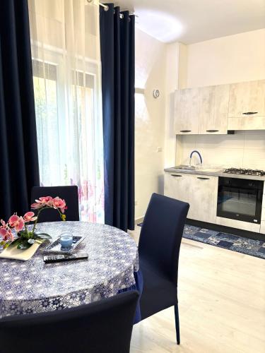 a kitchen with a table and chairs and a kitchen with a stove at Stefy's House in Scalea