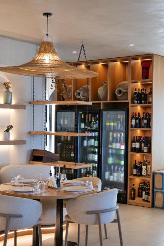 a restaurant with a table and chairs and a chandelier at Pampas Duplex Rooms in Durrës