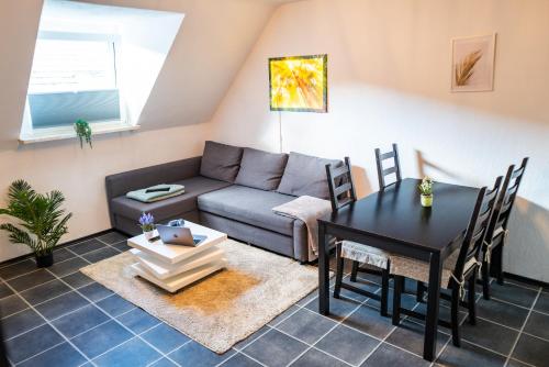 a living room with a couch and a table at #622 gemütliche Wohnung mit Disney,Prime und Netflix in Essen