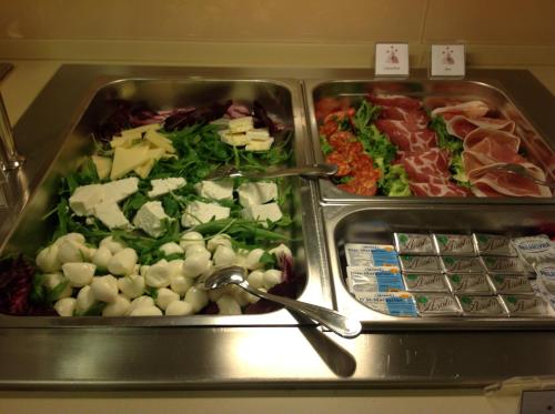 two trays of different types of food on a buffet at Domus Australia in Rome