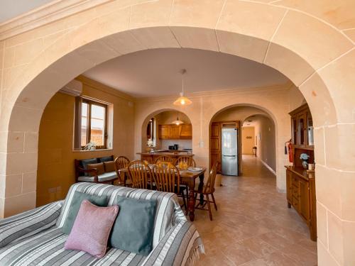 a living room with a couch and a table at Villa Fieldview - Gozo Holiday Home in Għarb