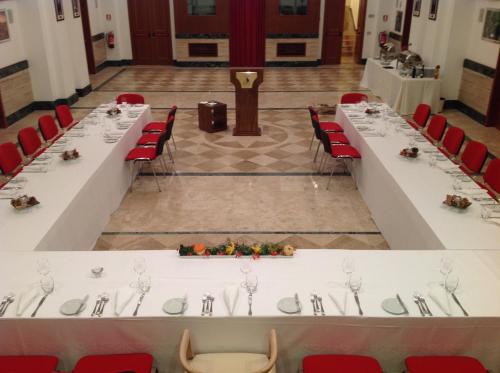 a long table in a room with red chairs at Domus Australia in Rome