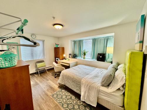 a bedroom with a bed and a desk and a window at Micro Studio Apartment 10 Minutes Walk to University of Washington in Seattle