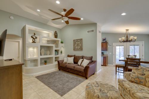 a living room with a couch and a ceiling fan at Golf and Hike Family Home with Patio in Glendale in Phoenix