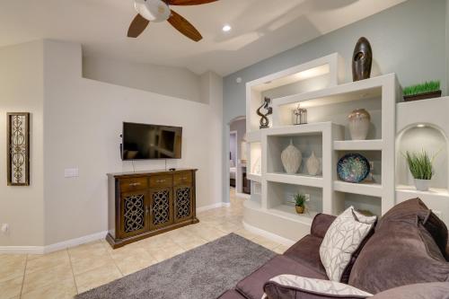 a living room with a couch and a flat screen tv at Golf and Hike Family Home with Patio in Glendale in Phoenix