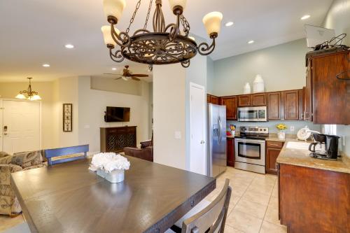 a kitchen with a wooden table and a dining room at Golf and Hike Family Home with Patio in Glendale in Phoenix