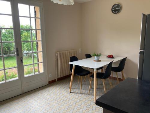 a dining room with a table and chairs and a window at Gîte en Bergeracois in Cours-de-Pile