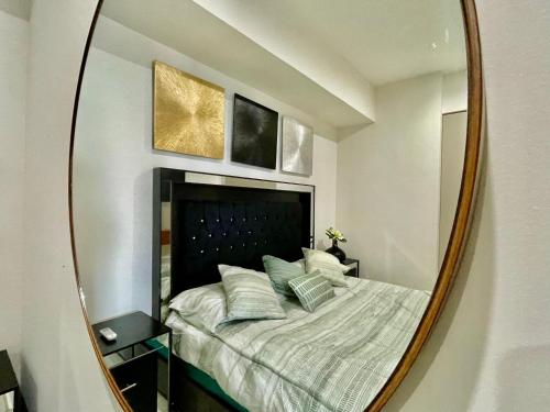 a bedroom with a bed in a mirror at Sunset Malecón View in Mazatlán