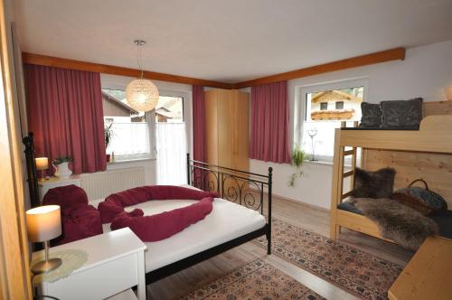 a living room with a bed and a fireplace at Haus Alpenglück in Kaunertal