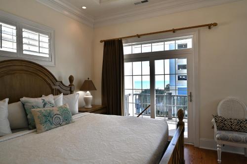 a bedroom with a bed and a balcony at 6BR Luxury Vacation Home - Unbeatable Location and View in Myrtle Beach