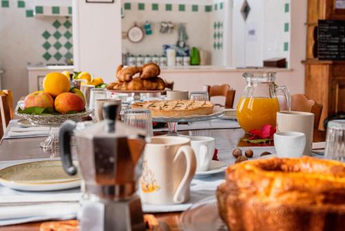 a table topped with plates of food and fruit at B&B Belvedere in Agropoli