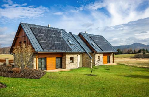 a house with solar panels on top of it at Pihel Apartments in Nový Bor