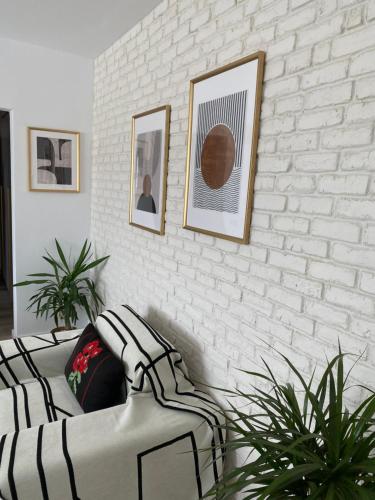 a living room with a couch and a brick wall at Apartament de lux in Tecuci
