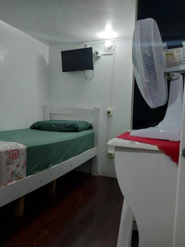 Ένα ή περισσότερα κρεβάτια σε δωμάτιο στο Quartos no centro de Itu - Hospedagem Elizabeth