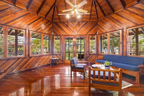 a living room with a blue couch and windows at Tambor Tropical Beach Resort- Adults Only in Tambor