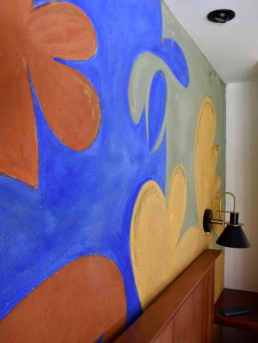 a wall with a blue and orange painting on it at Villa Cristal in Antigua Guatemala