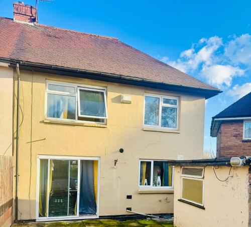 a yellow house with windows and a roof at Kidderminster West Midlands Birmingham 3 bedrooms in Kidderminster