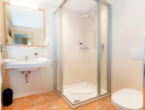 a bathroom with a shower and a sink and a toilet at Sun Valley - Wildschönau in Auffach