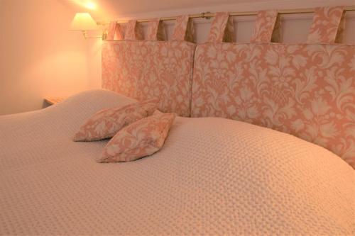 a bed with two pillows on top of it at Elm Cottage in Kippford
