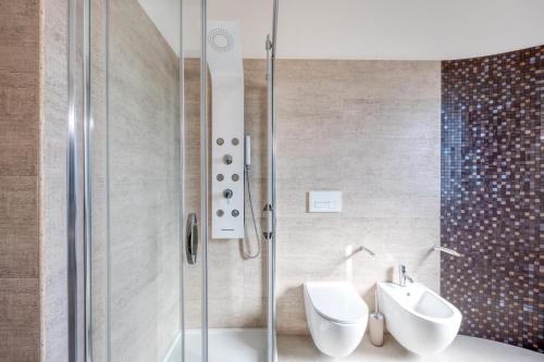 a bathroom with a shower and a sink and a toilet at Appartamento Rubino in Tricase