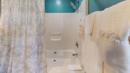 a bathroom with a shower with white towels at Host on the Coast in Folly Beach