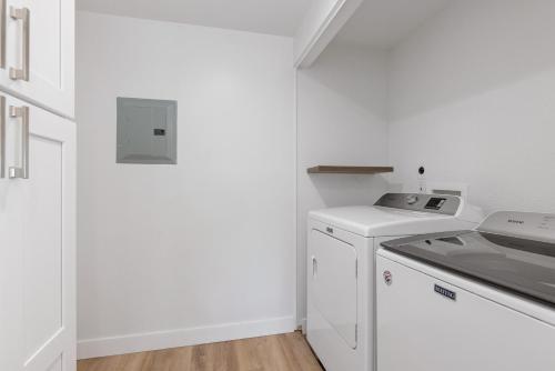 a white kitchen with a stove and a dishwasher at Trackside Tranquility - TC522B in Solana Beach