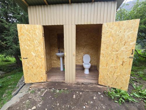 a house with a toilet and a sink in it at "Ethno Yurt Camp Argymak" Altyn Arashan in Mineralʼnyy Istochnik Altyn-Arasan