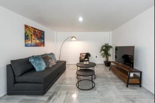 a living room with a couch and a table at Departamento en Coyoacán 7 in Mexico City