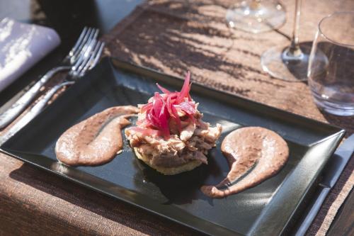a plate with a sandwich and pretzels on a table at La Tagliolina in Monteveglio