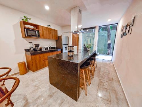 a kitchen with a large island in the middle at Premium Apartment in Tulum 2 Bedrooms Roof Top Pool - Aldea Zama in Tulum