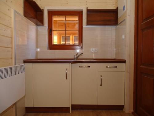 a kitchen with a sink and a window at Ośrodek Wypoczynkowy Inco in Międzywodzie