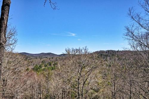 a view of a forest with trees and mountains at The Owlery in Highlands