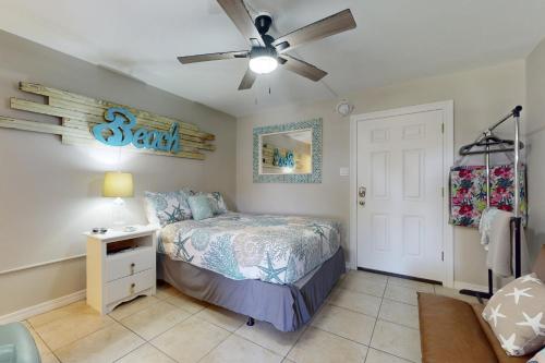 a bedroom with a bed and a ceiling fan at Beachview 205 in Gulf Shores