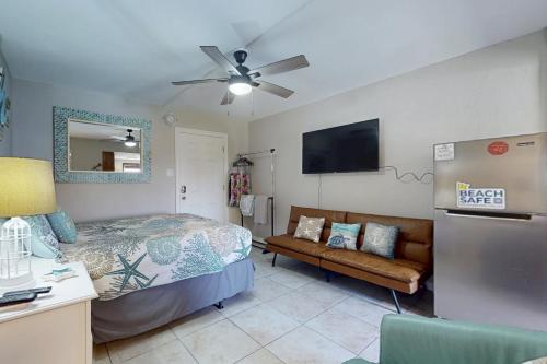 a bedroom with a bed and a couch at Beachview 205 in Gulf Shores