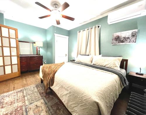 a bedroom with a bed and a ceiling fan at The Wildflower Cottage - Close to The Garden of the G O D s in Colorado Springs