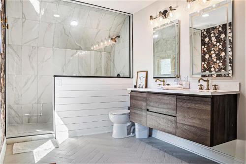 a bathroom with a shower and a sink and a toilet at Modern Retreat Games BBQ Grill Close to Downtown in Omaha