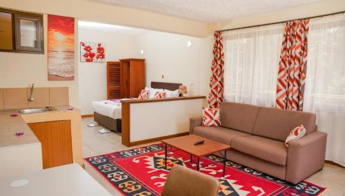 a living room with a couch and a bed at Matteos Italian Restaurant,Bar & Accommodation in Naivasha