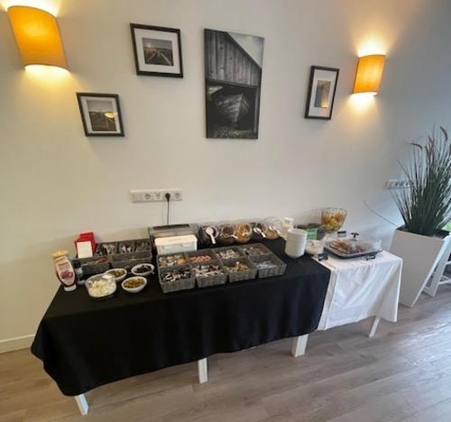 a table with a bunch of food on it at Hotel K1 Nohra - bei Weimar in Nohra