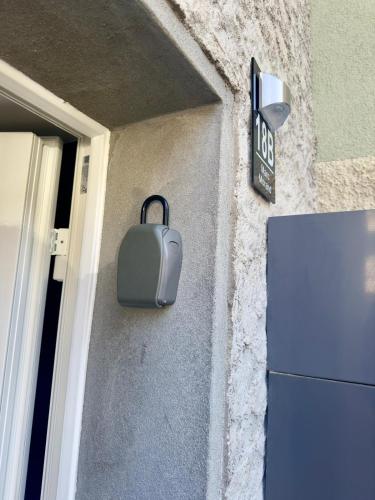 a briefcase hanging on the side of a building at Centre ville appartement cosy in Martigny-Ville