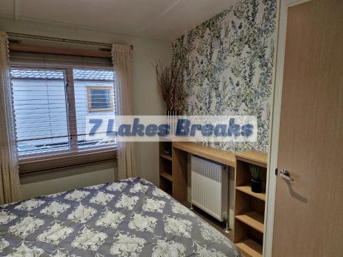 a bedroom with a bed and a window at 7 Lakes Breaks at 7 Lakes Country Park-WF73 in Crowle