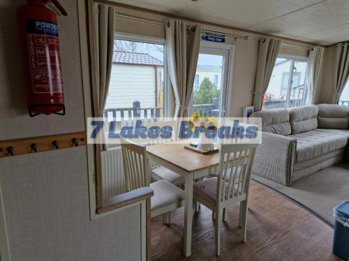 a living room with a table and a couch at 7 Lakes Breaks at 7 Lakes Country Park-WF73 in Crowle